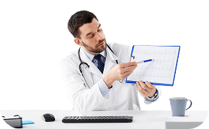 Physician reviewing a patient's health chart at his desk