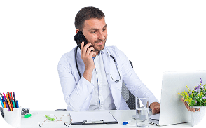 Physician on a phone call reviewing information on a laptop