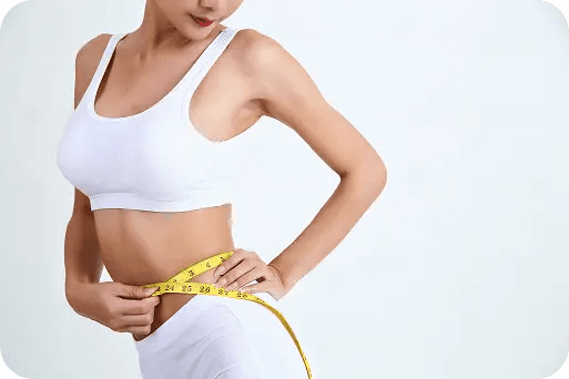 Person measuring waist progress during a weight loss journey